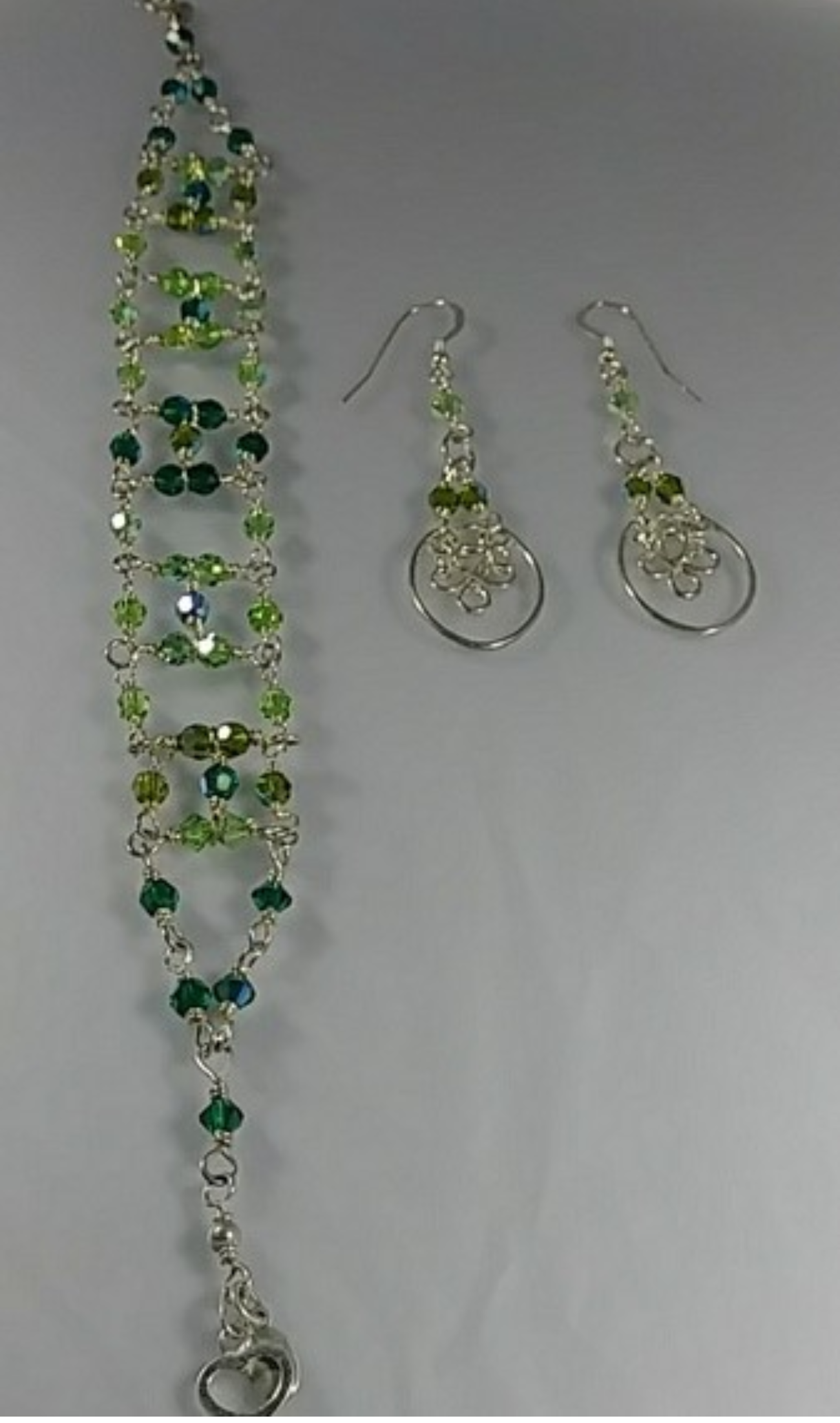 (223 - BCT) - Description: Handcrafted Bracelet/Earrings:– Measures Approximately: (Bracelet: Adjustable: 8 - 9 1/2" L x 3/4" W) –– (Earrings: 2 1/4" L x 3/4" W) MATERIAL: Sterling Silver Wire / 4 mm Swarovski Austrian AB Crystal