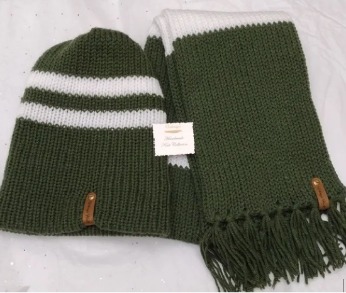 Item # 904 - Unisex Accessories -Material: 100% Acrylic Yarn, Custom Riveted Faux Leather Tags Construction: Double Layered Knit Scarf and Beanie Color(s): Forrest Green and White Size: OS Stretchable