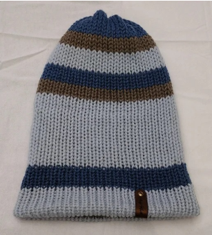 Item # 2002 - Unisex Accessory - Material: 100% Acrylic Yarn / Custom Faux Leather Tag - Care: Hand Wash, Cold Water, Dry Flat - Construction: Reversible, Double Layered Knit Beanie (handmade) - Size: Adult (One Size) Stretchable - Color(s): Blues and Putty - Item packed in clear resealable plastic storage bag