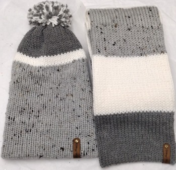 Item # 906 - Unisex Accessories - Material: 100% Acrylic Yarn, Custom Riveted Faux Leather Tags Construction: Double Layered Knit Scarf and Beanie Color(s): Tweed, Gray and White Size: OS Stretchable