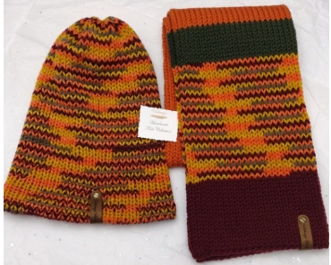 Item #907 - Unisex Accessories -Material: 100% Acrylic Yarn, Custom Riveted Faux Leather Tags Construction: Double Layered Knit Scarf and Beanie Color(s): Burgundy, Pumpkin, Green and Mixed-Colored Yarn Size: OS Stretchable